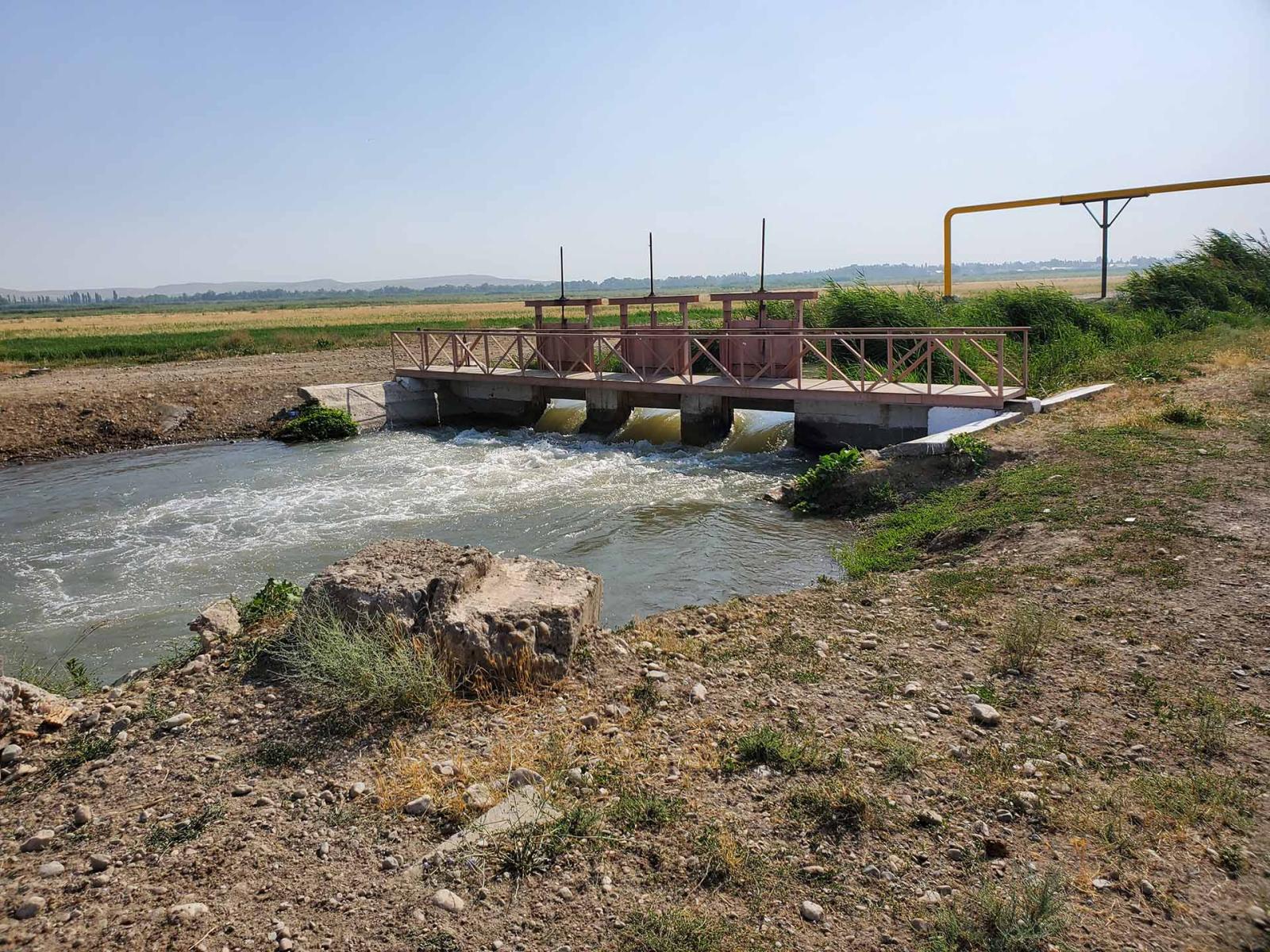 Water running under bridge through stream